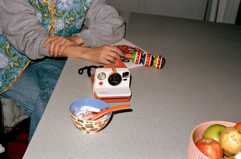 Aparat natychmiastowy POLAROID Now Gen 3 na stole Zakres przysłon f/11–f/64 zdjęcia w słabym oświetleniu system migawki napędzany silnikiem krokowym