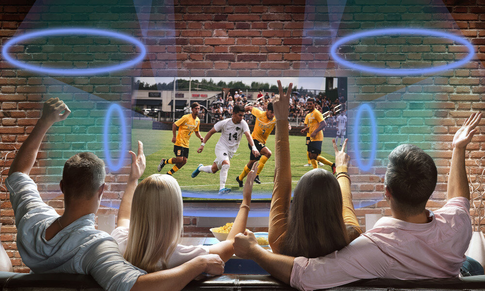 Telewizor THOMSON 50QG7C14 Dolby Atmos przestrzenny dźwięk, telewizor wiszący na ścianiem osoby oglądające mecz