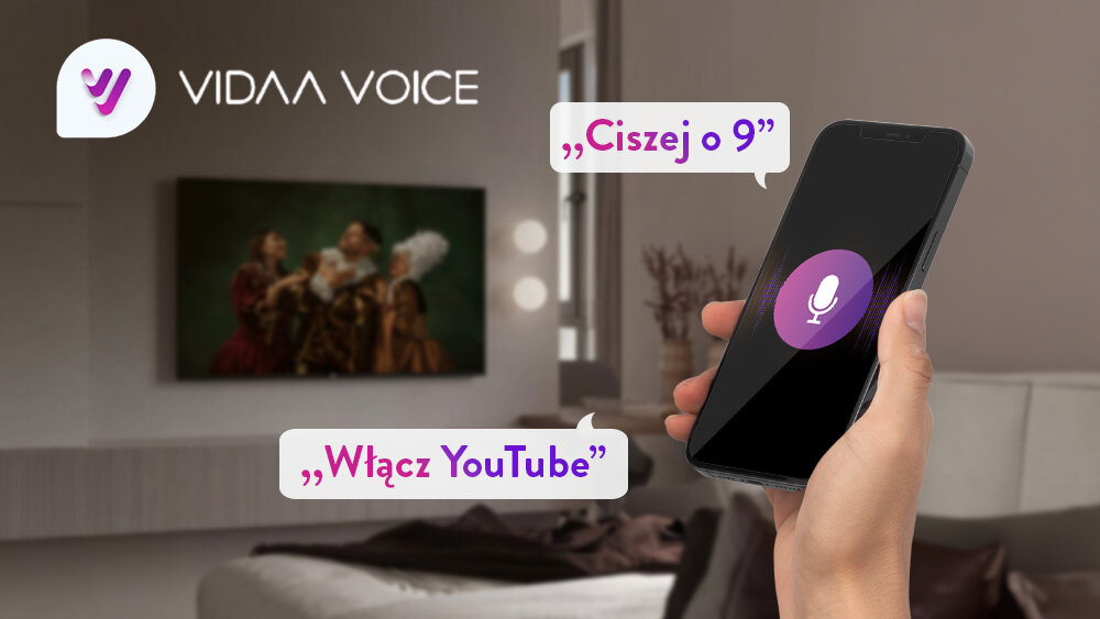 Telewizor JVC LT-40VDF5400 - Sterowanie głosowe z asystentem, ręka trzymająca smartfona z funkcją głosową, w tle telewzior zawieszony na ścianie