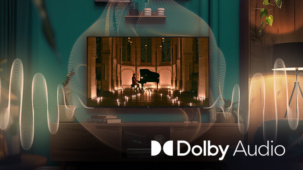 Telewizor JVC LT-43VD3500 - Pełne brzmienie z Dolby Audio, obraz pokazujący faune morską z rybami, telewizor stojący na stoliku z którego wydobywa się dźwięk