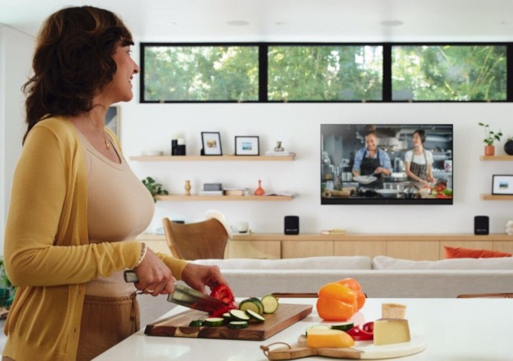 Telewizor PANASONIC TV77Z93AEG Alexa sterowanie głosowe inteligentny dom, osoba krojąca warzywa, oglądająca program kulinarny