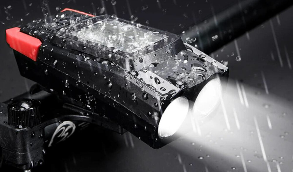 Zestaw lampek rowerowych EXTRALINK z licznikiem 14480 ciemne tło przednia lampka umieszczona na kierownicy rowerowej krople wody na lampce oświetlenie pomiar prędkości bezpieczeństwo komfort