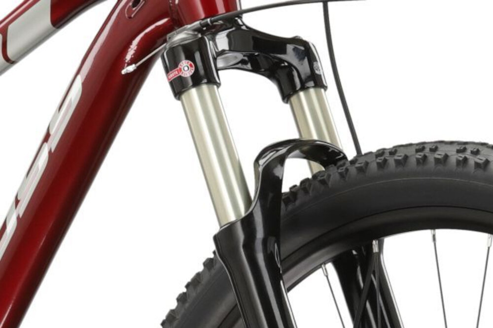 Rower górski MTB KROSS Level 6.0 M17 29 cali męski Rubinowo-srebrny zbliżenie na amortyzator rower typu hardtail przedni amortyzator marki SR SUNTOUR typ Raidon RLR ze skokiem 100 mm ułatwia najeżdżanie na przeszkody niweluje wstrząsy niska masa roweru duża sztywność regulacja za pomocą sprężyny obsługa poprzez pokręteł na goleni