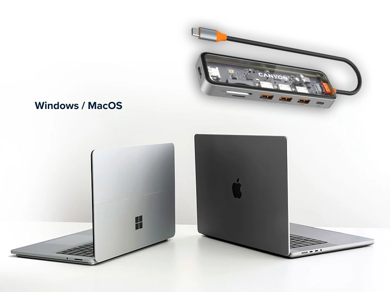 Na obrazie widoczne są dwa laptopy, jeden z logo okien, drugi z logo jabłka, oraz przezroczysty hub USB-C z napisem \'CANYON\'. Obok laptopów znajduje się tekst \'Windows / MacOS\'.
