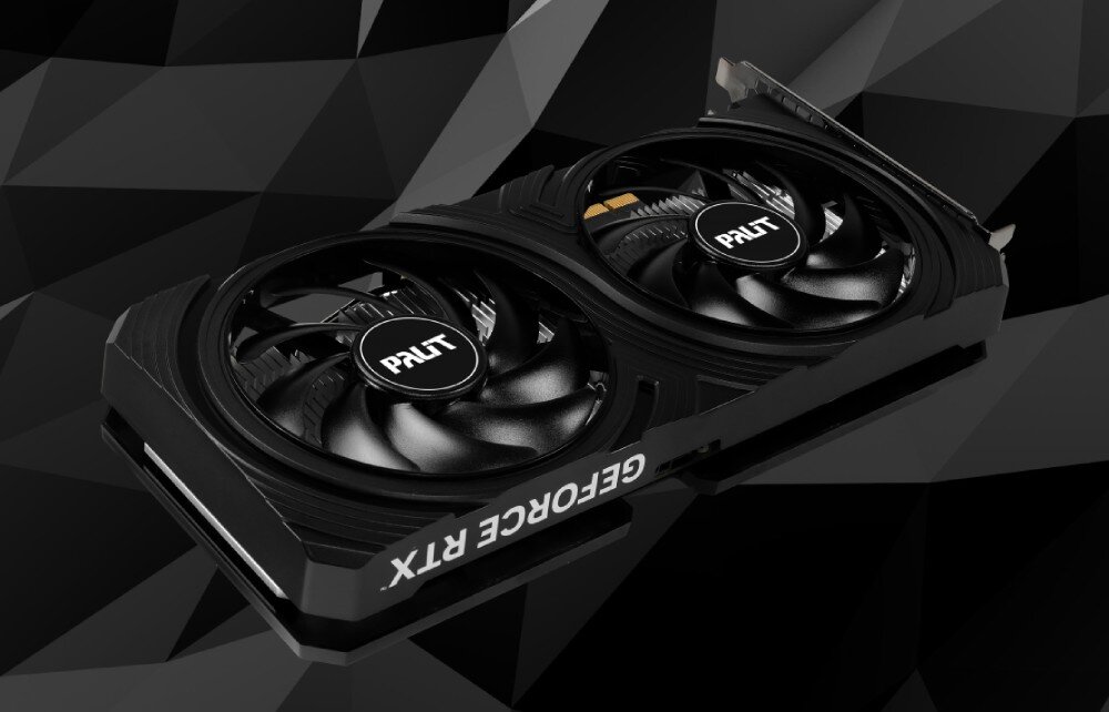 Komputer MAD DOG DIAXID605F-A11WB16WPV2 Karta graficzna z dwoma dużymi wentylatorami, widziana z góry na tle czarnej, geometrycznej powierzchni, grafika, architektura, wydajność