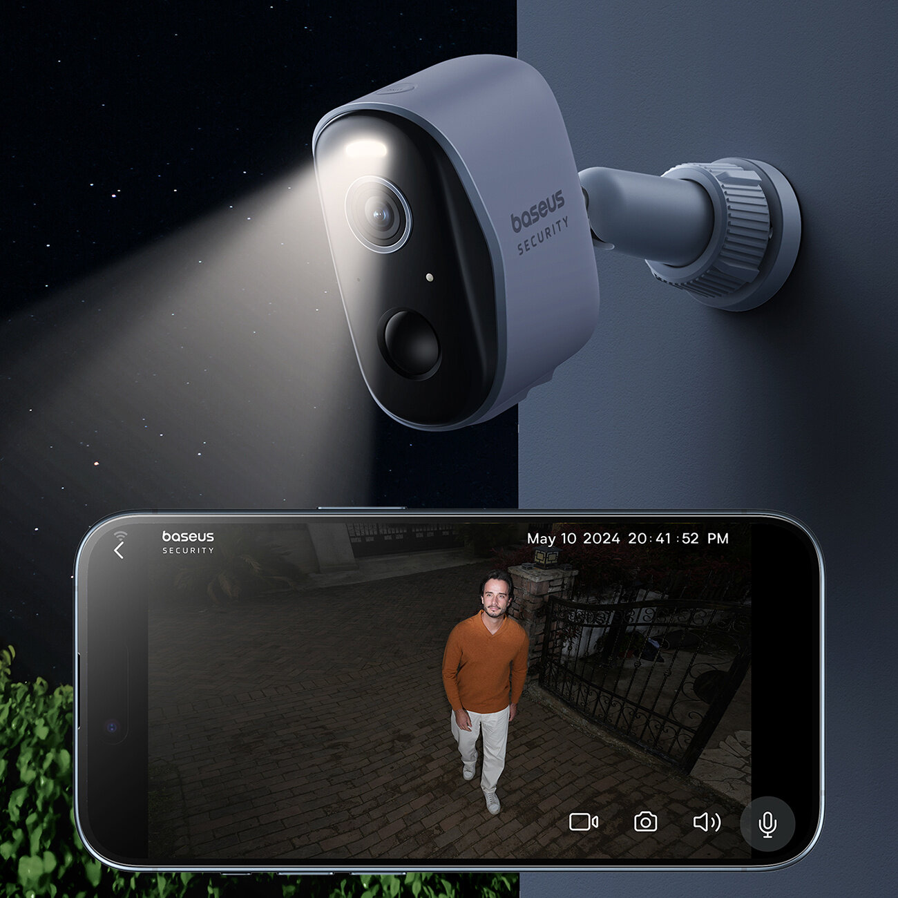 Na obrazie widoczna jest kamera zewnętrzna z napisem \'baseus SECURITY\', emitująca światło. Obok znajduje się ekran telefonu pokazujący obraz z kamery, na którym widać osobę stojącą na zewnątrz, z datą i godziną \'May 10 2024 20:41:52 PM\'.