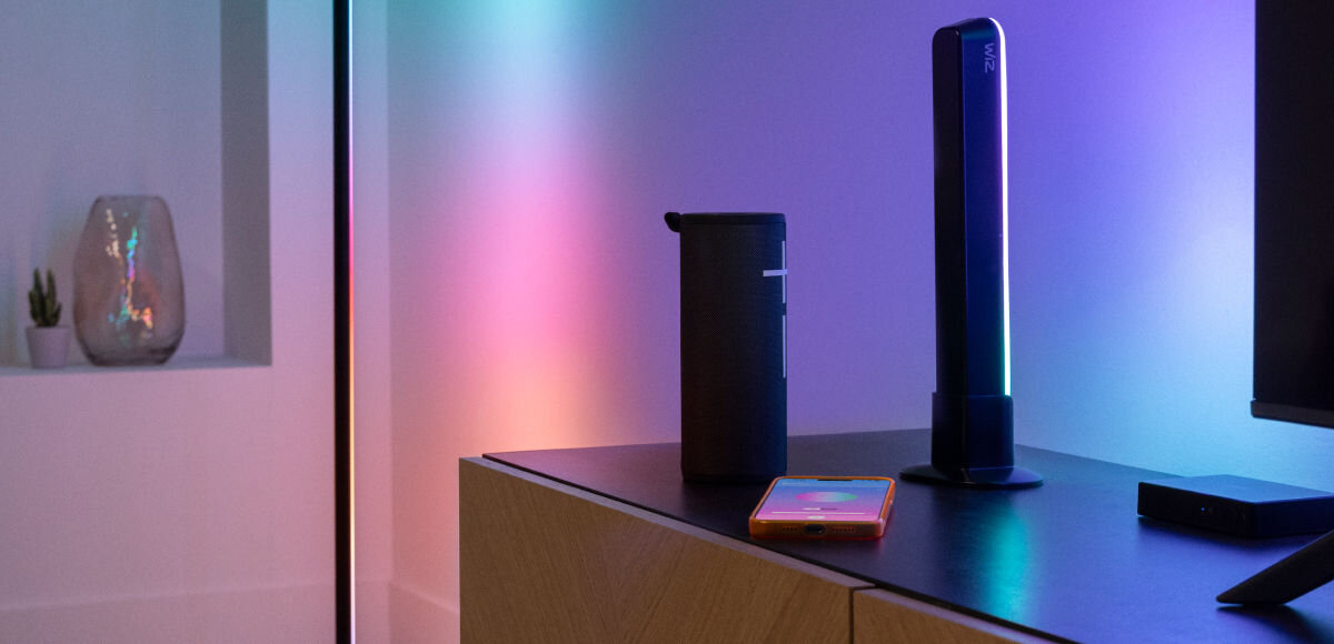 Taśma LED WIZ Sync Box do TV 55 - 65 2.6 m Wi-Fi, Harmonia światła z muzyką, Telefon na blacie, obok głośnik i taśma LED