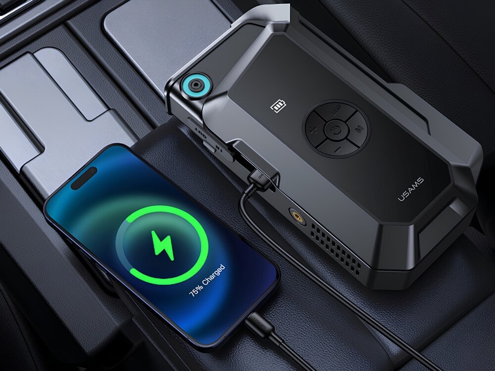 Na obrazie widać czarne urządzenie rozruchowe z napisem \'USAMS\' oraz smartfon z wyświetlaczem pokazującym ikonę ładowania i tekst \'75% Charged\'.