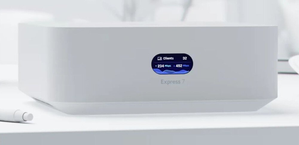 Router UBIQUITI UniFi Express 7 (UX7-EU) Frontowe ujęcie białego urządzenia z wyświetlaczem pokazującym parametry sieci oraz napis 'Express 7'