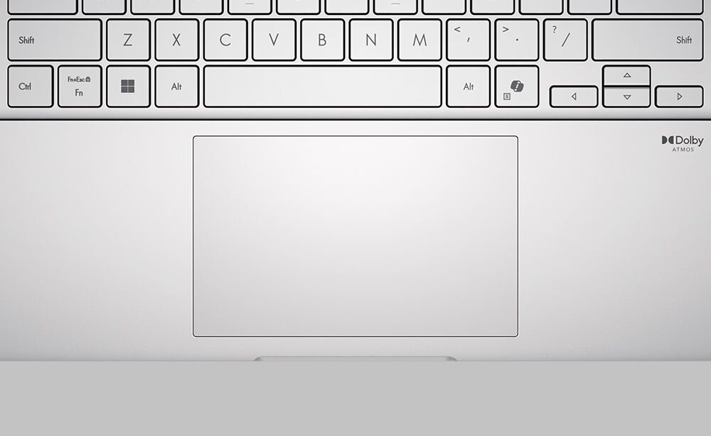 Zbliżenie na klawiaturę i duży touchpad laptopa ASUS VivoBook S 14 w kolorze srebrnym, w prawym górnym rogu widoczne logo Dolby Atmos, minimalistyczny design, wyraźne oznaczenia klawiszy. - Touchpad o powiększonej powierzchni