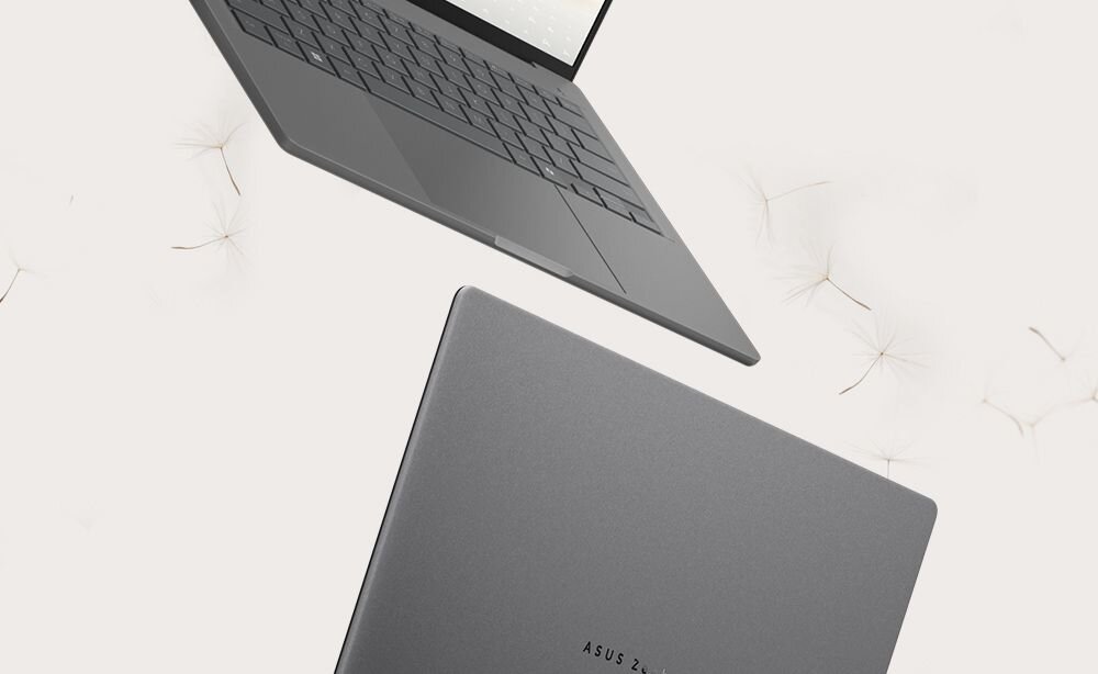 Laptop ASUS Zenbook w kolorze szarym unoszący się nad beżowym tle z nasionami dmuchawca, demonstracja odporności na zarysowania dzięki materiałowi Ceraluminum odpornemu na tarcie i ścieranie - Odporność na zarysowania