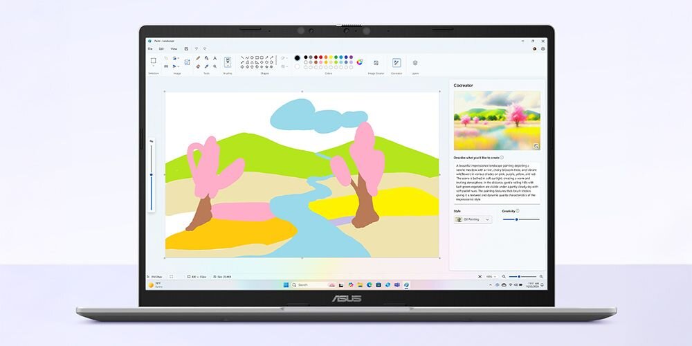 Laptop ASUS VivoBook 14 z otwartą aplikacją Cocreator w Microsoft Paint wyświetlającą kolorową ilustrację krajobrazu z różowymi drzewami, rzeką i górami oraz panel Cocreator z opcjami AI po prawej stronie - Funkcja Cocreator