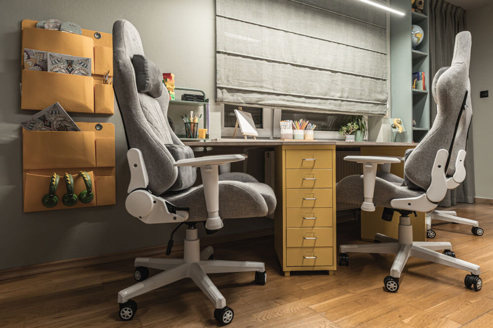 Fotel gamingowy HELL'S CHAIR HC 1006 Szaro-biały prezentacja fotela w pokoju przy biurku do 120 kg bezpieczne stabilne użytkowanie trwałość wygoda