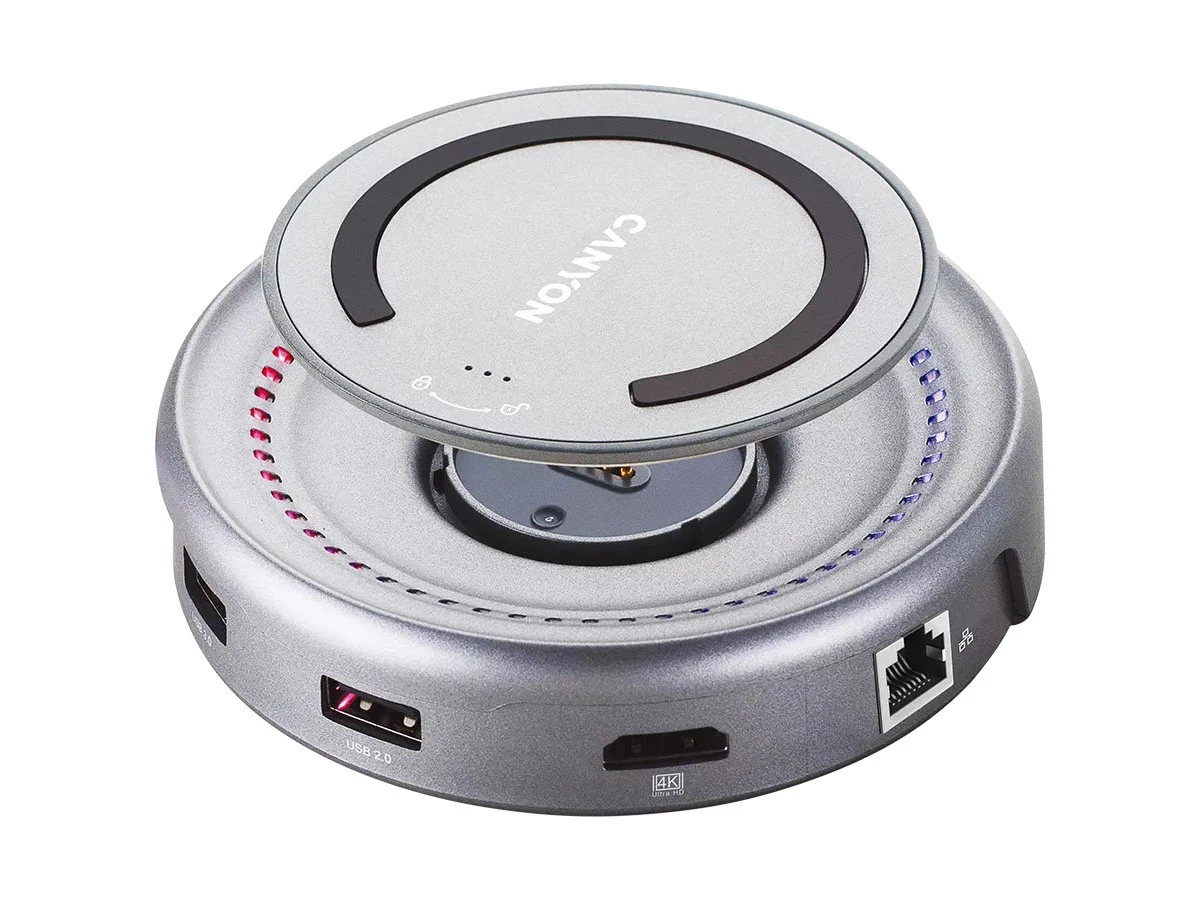 Na obrazie widoczny jest okrągły, szary hub USB z logo \'CANYON\' na górze. Posiada różne porty, w tym USB 2.0 i Ethernet, oraz oznaczenie \'4K Ultra HD\'.