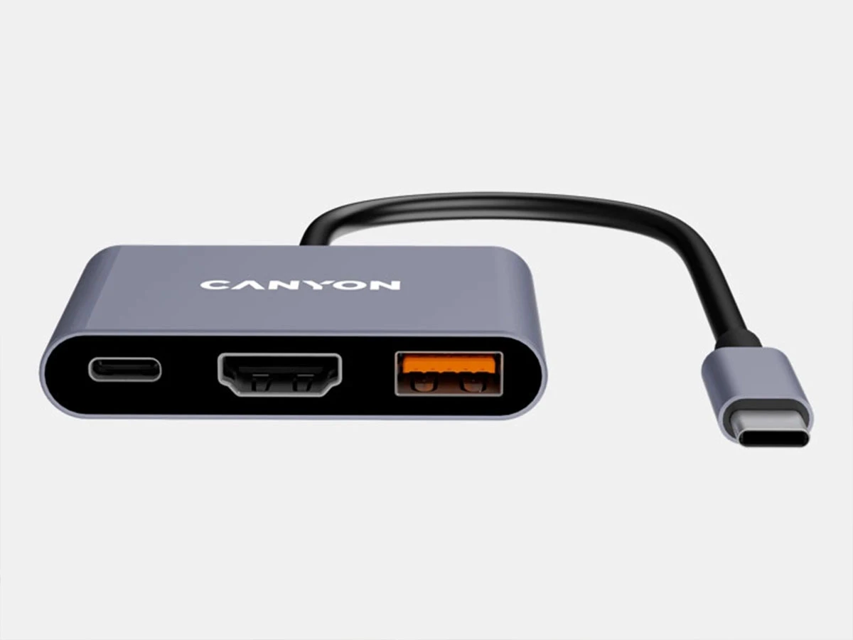 Szary hub USB-C z trzema portami: USB-C, HDMI i USB-A. Na urządzeniu widoczne jest logo \'CANYON\'.