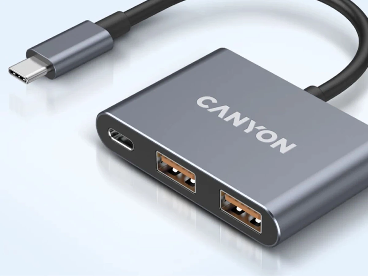 Szary hub USB-C z dwoma portami USB i jednym portem USB-C. Na urządzeniu widoczne jest logo \'CANYON\'.