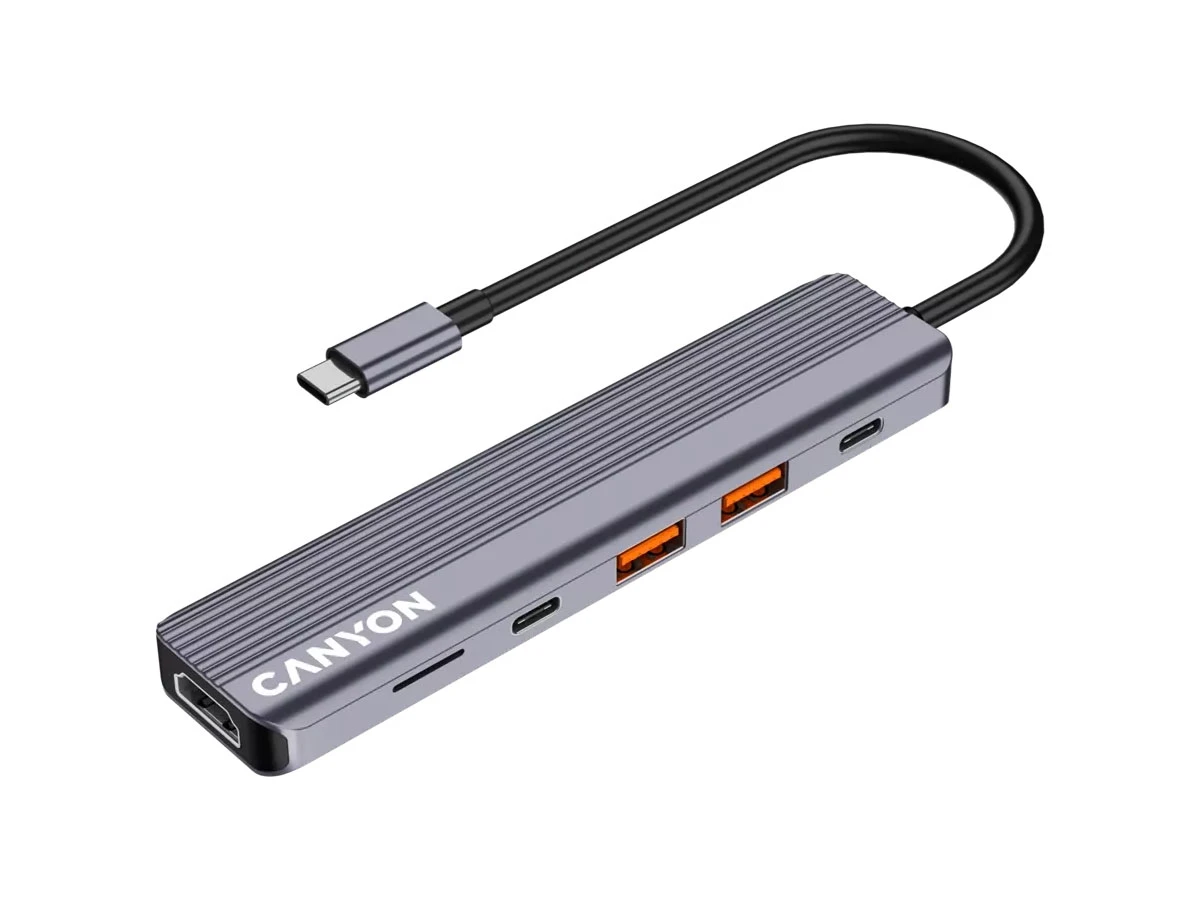 Szary hub USB-C z kilkoma portami, w tym dwoma pomarańczowymi portami USB i jednym portem HDMI. Na urządzeniu widoczne jest logo \'CANYON\'.