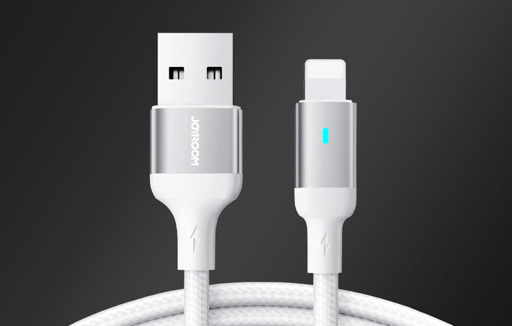 Na obrazie widoczny jest biały kabel USB-A do Lightning z metalicznymi końcówkami, na jednej z nich znajduje się logo \'Joyroom\'.