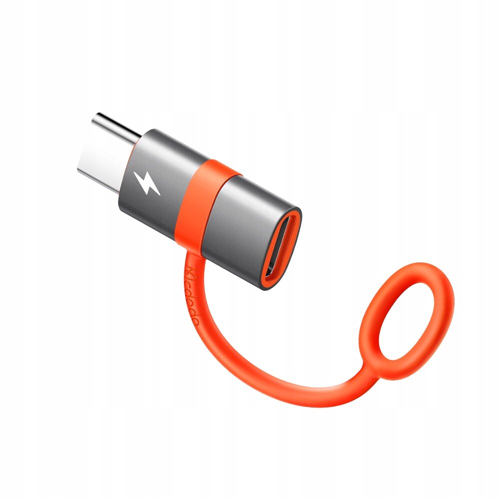 Na obrazie widoczny jest adapter USB-C do Lightning w kolorze szaro-pomarańczowym z symbolem błyskawicy. Adapter ma elastyczny pomarańczowy uchwyt z napisem \'Mcdodo\'.