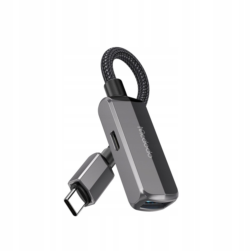 Na obrazie widoczna jest przejściówka USB-C na USB z plecionym kablem. Na obudowie znajduje się napis \'mcdodo\'.