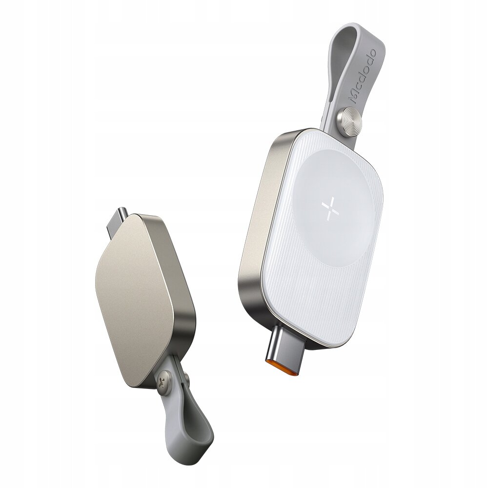 Obraz przedstawia dwie ładowarki indukcyjne z metalicznym wykończeniem i logo \'Mcdodo\' na pasku. Jedna z ładowarek ma widoczny port USB-C i okrągłą powierzchnię ładowania z symbolem plusa.