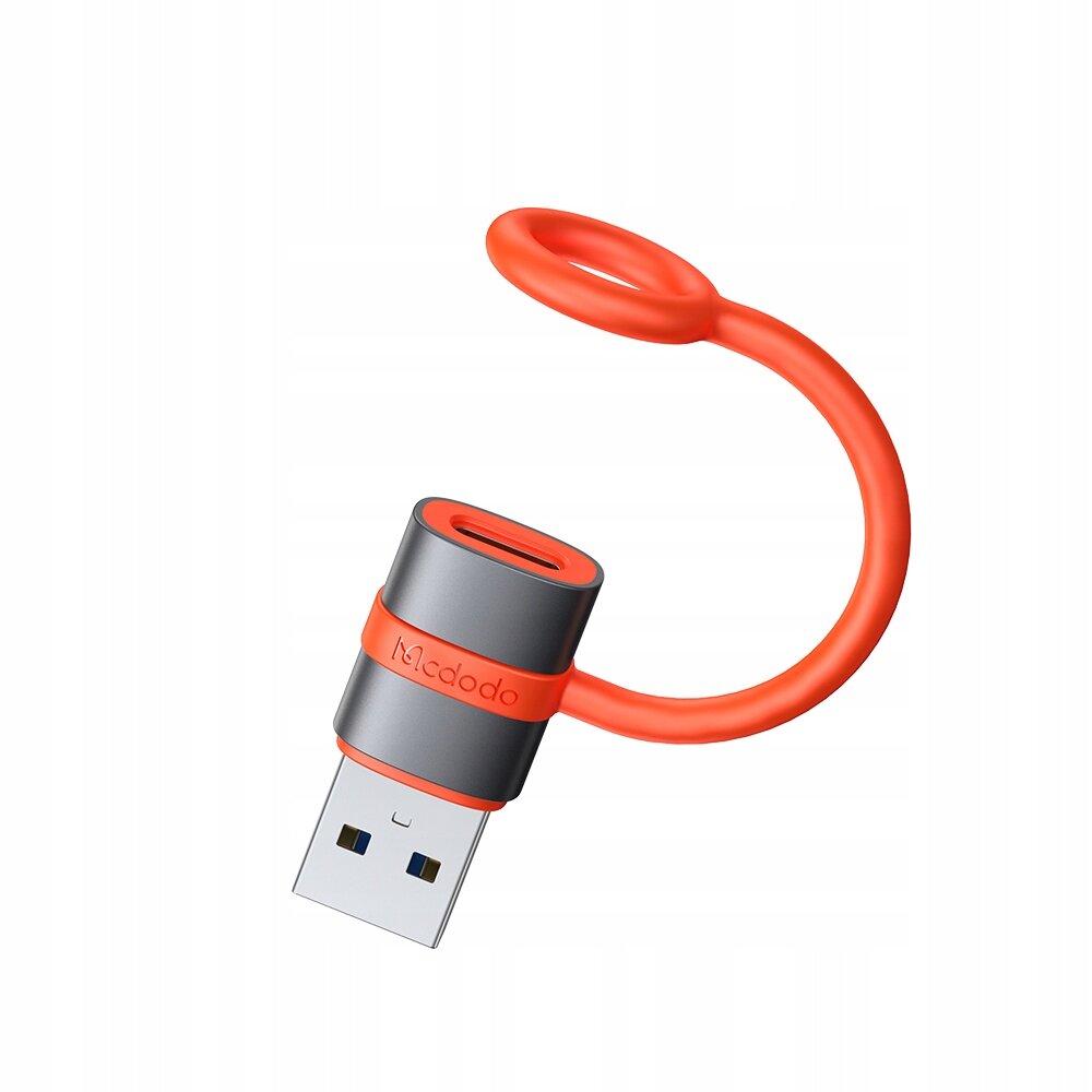 Na obrazie widoczny jest adapter USB z szarym korpusem i pomarańczowym kablem. Na adapterze znajduje się napis \'Mcdodo\'.