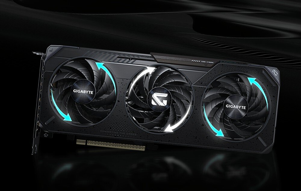 Karta graficzna GIGABYTE GeForce RTX 5060 Ti Gaming OC 16GB Frontowy widok karty z zaznaczonymi strzałkami wskazującymi przeciwny kierunek obrotu środkowego wentylatora w stosunku do bocznych, system chłodzenia, wentylatory, ciepłowody, miedziana płytka