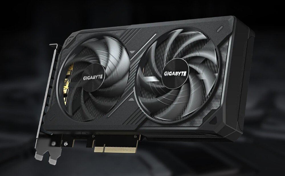 Karta graficzna GIGABYTE GeForce RTX 5060 Ti Windforce 16GB Karta graficzna z dwoma wentylatorami sfotografowana z boku, na tle rozmytych elementów sprzętu komputerowego, architektura, parametry, pamięć, rdzenie CUDA