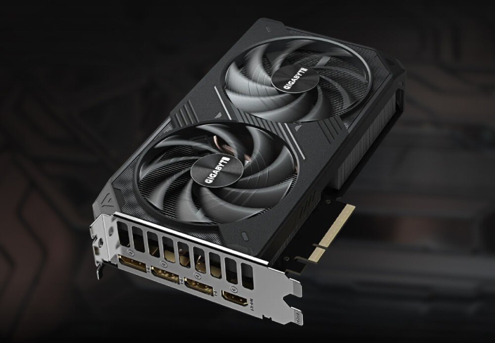 Karta graficzna GIGABYTE GeForce RTX 5060 Ti Windforce 16GB Karta graficzna z dwoma wentylatorami i panelem z portami wideo, widoczna z lekkiego kąta na ciemnym tle, wentylacja