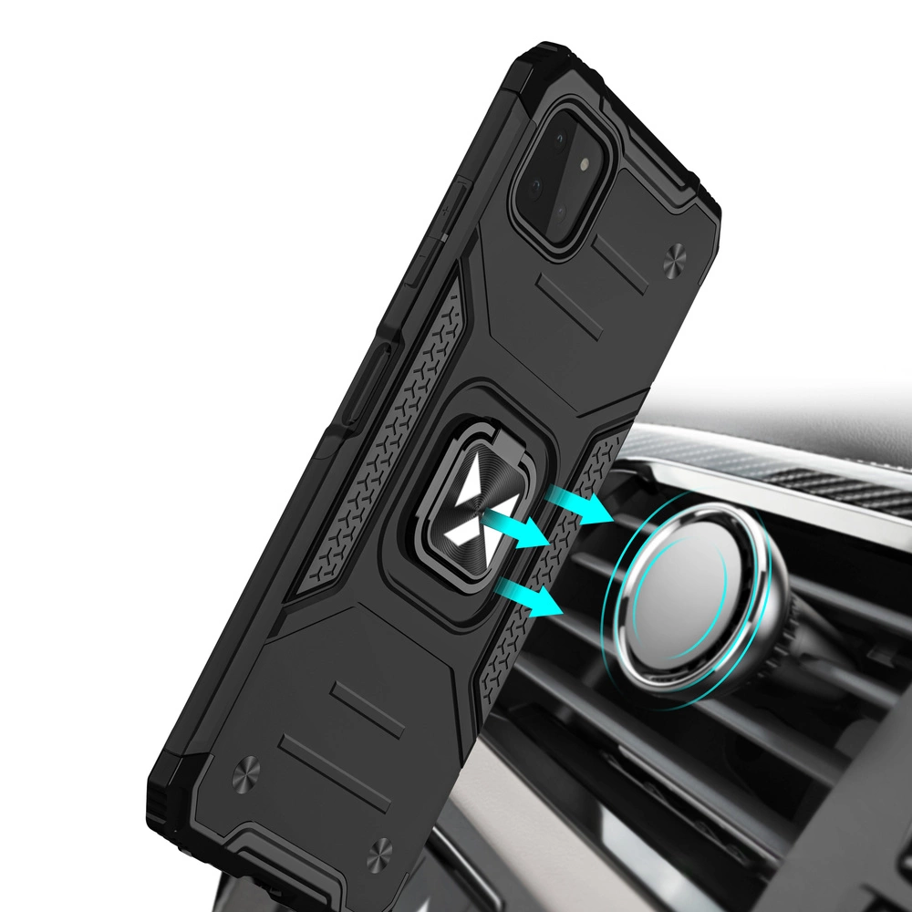 Czarne, pancerne etui na telefon z wbudowanym magnetycznym uchwytem jest pokazane w pobliżu okrągłego uchwytu samochodowego. Etui ma wyraźne wzory i tekstury na powierzchni.