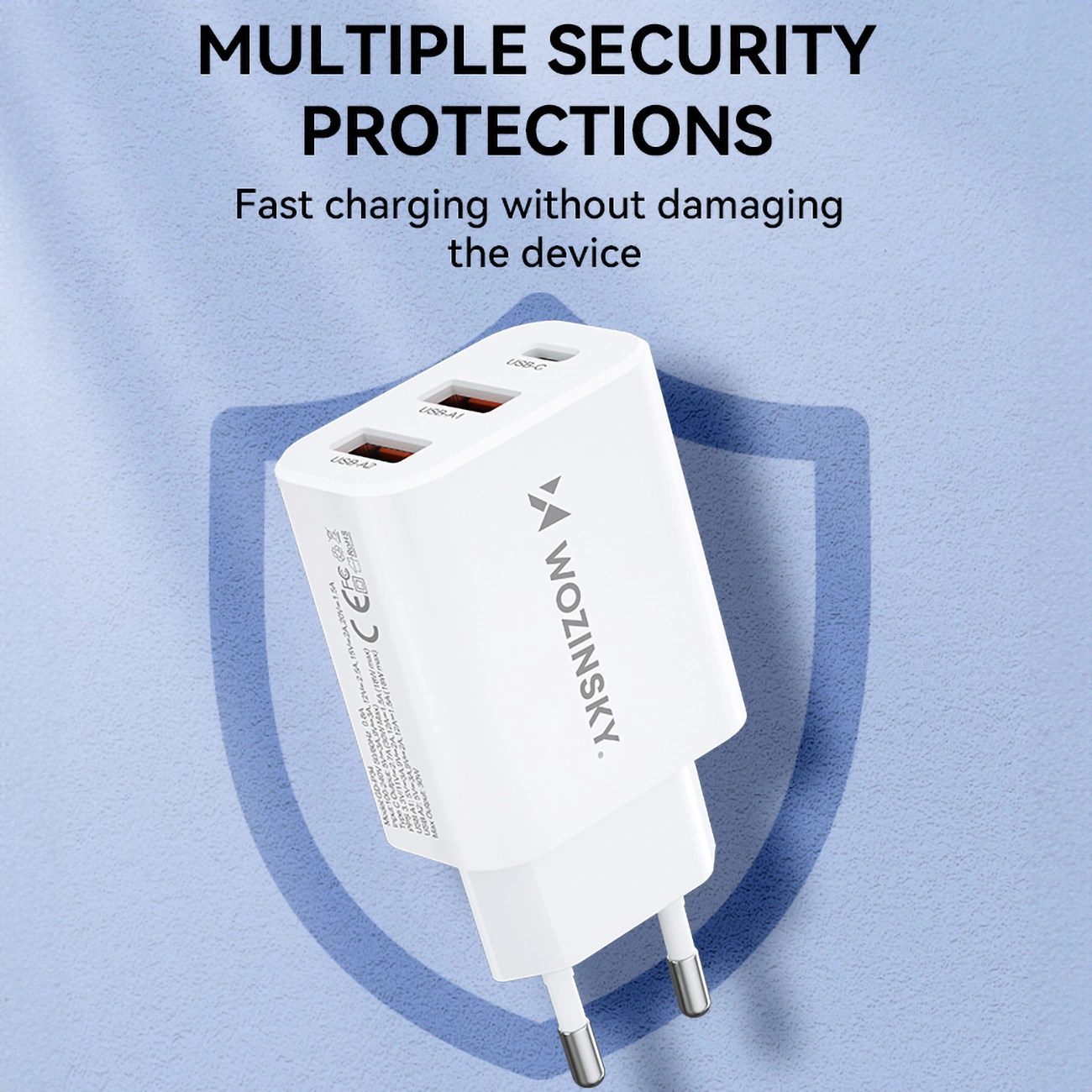 Biała ładowarka sieciowa z trzema portami: USB-C i 2 x USB-A, z logo \'WOZINSKY\'. Na tle widoczny jest tekst: \'MULTIPLE SECURITY PROTECTIONS Fast charging without damaging the device\'.
