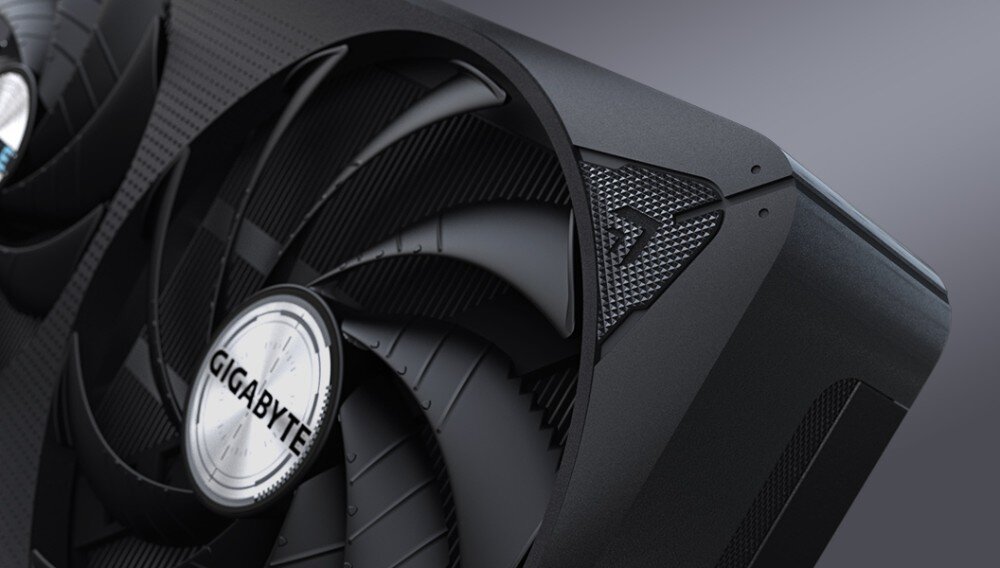 Karta graficzna GIGABYTE GeForce RTX 5060 Ti Eagle OC 8GB Zbliżenie na fragment obudowy karty z widocznym jednym z wentylatorów i fakturą powierzchni o wzorze siatki, wygląd, obudowa
