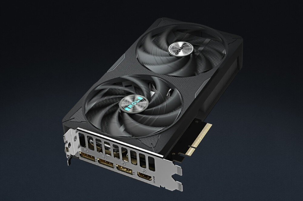 Karta graficzna GIGABYTE GeForce RTX 5060 Ti Eagle OC 8GB Karta graficzna widoczna od góry, z dwoma wentylatorami i czterema portami wylotowymi na śledziu, na ciemnym tle, konstrukcja, żywotność, komponenty