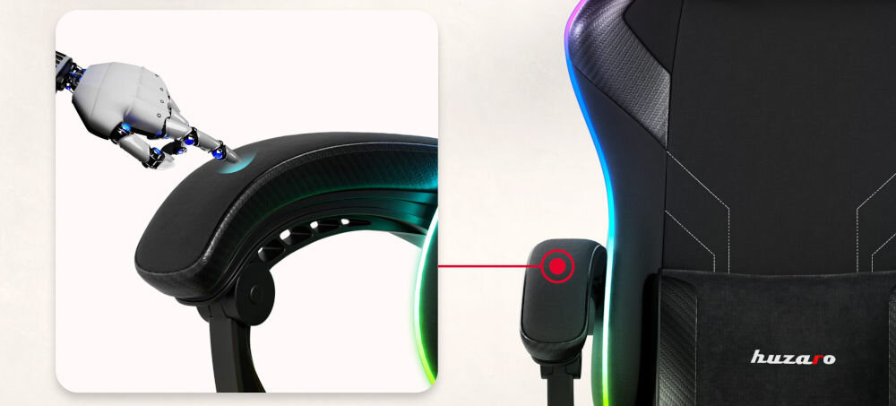 Fotel HUZARO Force 3.7 RGB Czarny zbliżenie na podłokietnik robot dotykający podłokietnik tło jasny delikatny gradient miękkość trwały materiał delikatna pianka komfort stabilne podparcie dla przedramion