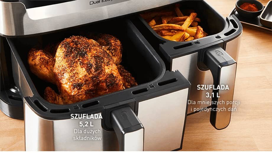 Obraz przedstawia frytkownicę beztłuszczową z dwoma szufladami, w jednej z nich znajduje się pieczony kurczak, a w drugiej frytki. Widoczny tekst: \'SZUFLADA 5,2 L Dla dużych składników\' oraz \'SZUFLADA 3,1 L Dla mniejszych porcji i pojedynczych dań\'.