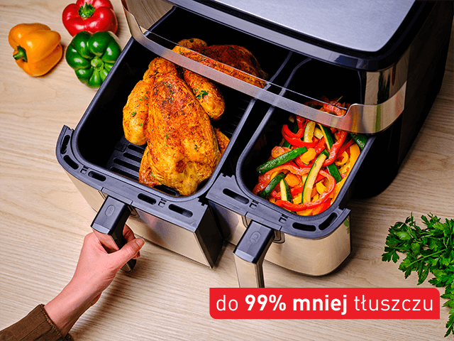 Frytkownica beztłuszczowa z dwoma koszami, w jednym z nich znajduje się pieczony kurczak, a w drugim kolorowe warzywa. Na obrazie widoczny jest tekst: \'do 99% mniej tłuszczu\'.