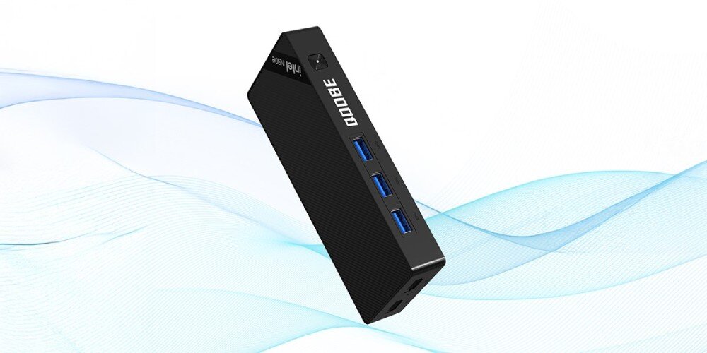 Komputer QOOBE SUC N150 Komputer unoszący się na tle jasnych fal graficznych, z trzema portami USB typu A i logo 'QOQBE' oraz 'Intel Inside', wielkość, wymiary, mobilność, wykonanie