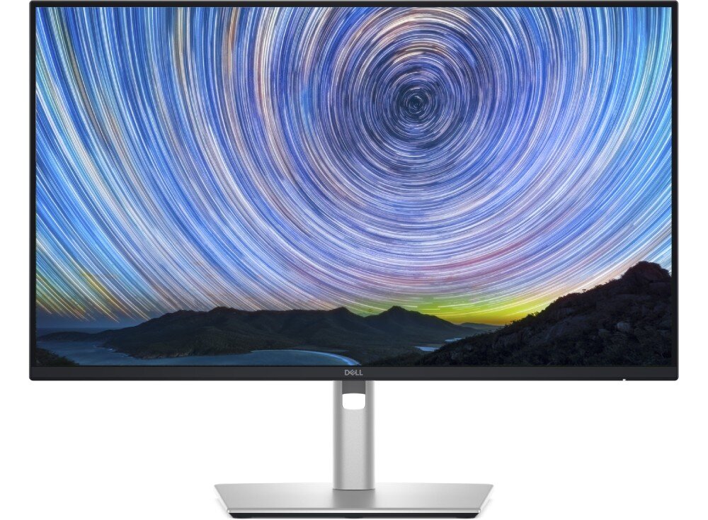 Monitor DELL P2425DE Monitor ze smukłą ramką stojący na podstawie, wyświetlający grafikę obracających się gwiazd na nocnym niebie nad górskim krajobrazem