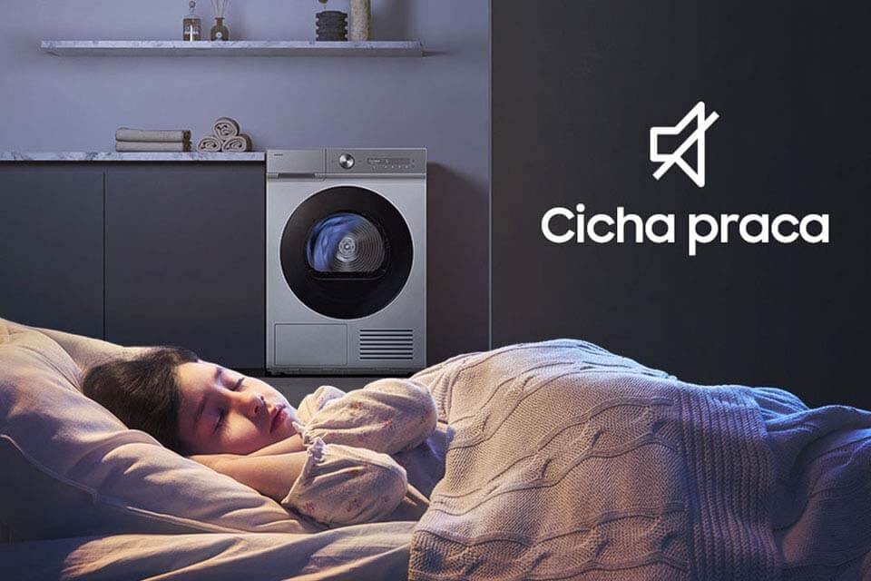 Program ciche suszenie Obraz przedstawia osobę śpiącą w łóżku obok suszarki. Obok widoczny jest symbol wyciszenia i tekst \'Cicha praca\'.