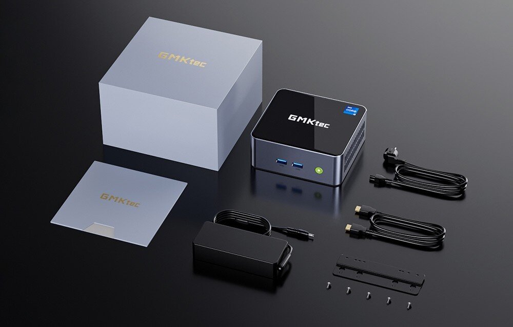 Komputer GMKTEC NucBox M3 Plus Zestaw akcesoriów obok małego komputera obejmujący pudełko, zasilacz, kable, uchwyt montażowy i dokumentację