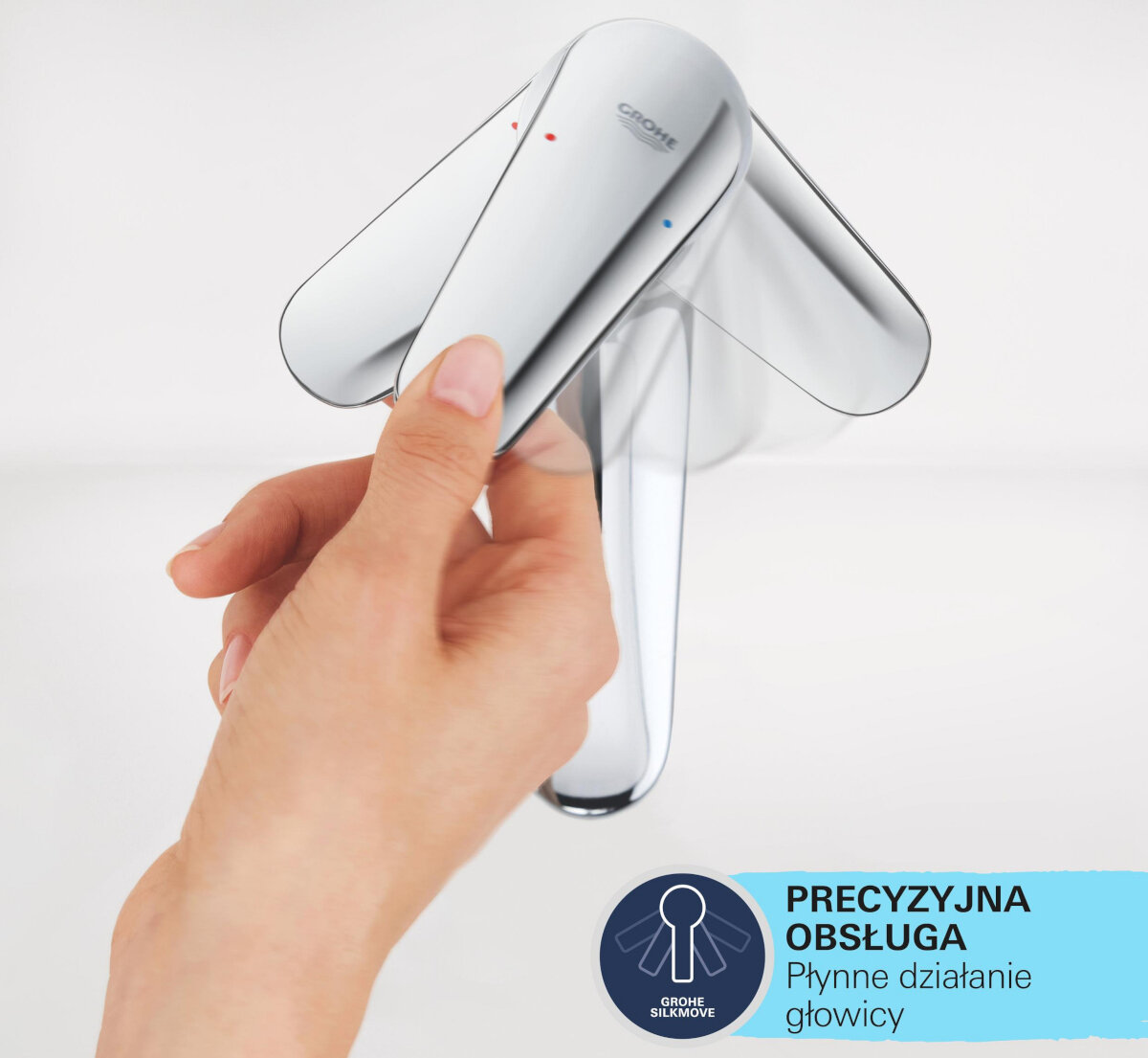 BATERIA UMYWALKOWA GROHE BAULOOP 23337000 CHROM Zdjęcie pokazuje dłoń dotykającą uchwytu chromowanej baterii, a obok znajduje się grafika z informacją „PRECYZYJNA OBSŁUGA – Płynne działanie głowicy” bezawaryjna obsługa ceramiczna głowica silkmove płynna regulacja temperatury precyzyjny strumień wody metalowa dźwignia
