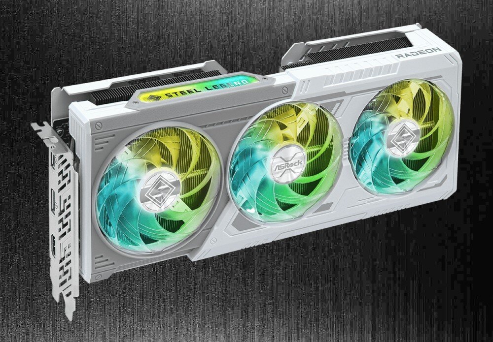 Karta graficzna ASROCK Radeon RX 9060 XT Steel Legend 16GB OC Skośny widok całej karty graficznej z trzema wentylatorami i podświetlanym napisem 'Steel Legend'. Obudowa w kolorze białym z geometrycznymi akcentami, porty, złącza, rozdzielczość, monitory