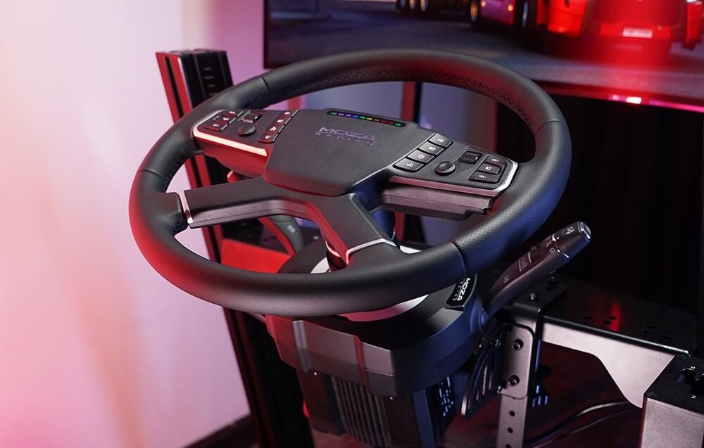 Manetki MOZA Racing RS065 Kierownica gamingowa z zamontowanymi manetkami stojąca naprzeciwko szerokiego monitora manetki wielofunkcyjne realizm sterowania wytrzymała konstrukcja rozbudowana funkcjonalność