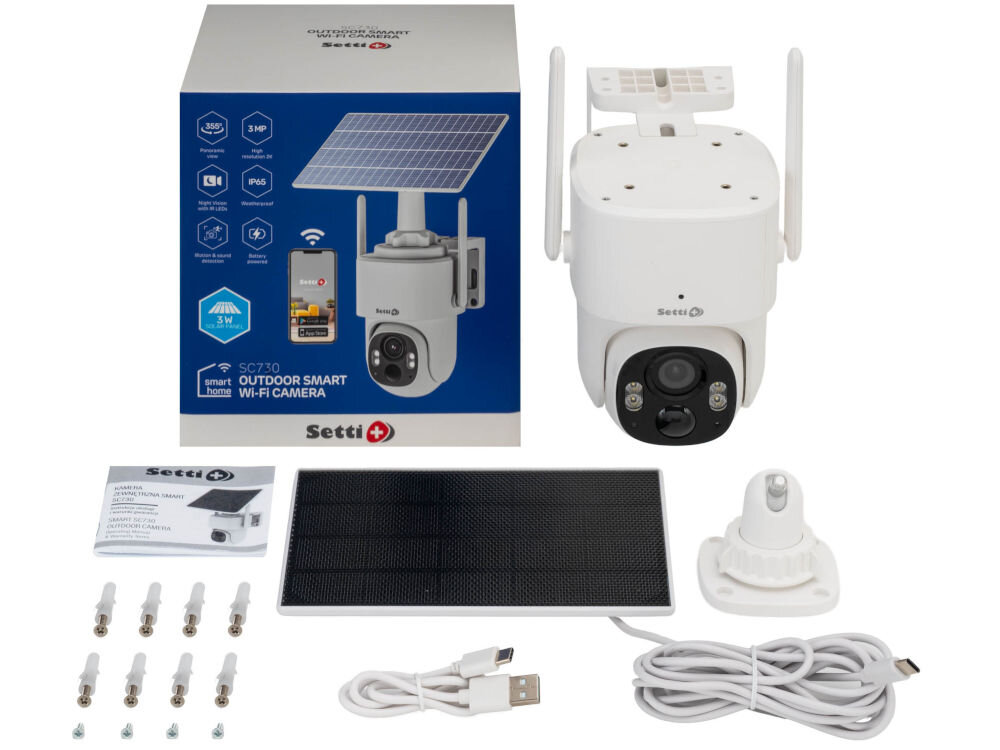 Na obrazie znajduje się zestaw kamery IP Setti+ Smart SC730, w skład którego wchodzą: kamera obrotowa, panel słoneczny, uchwyt montażowy, kabel USB oraz instrukcja obsługi. Opakowanie produktu jest widoczne z grafiką kamery i panelu słonecznego oraz logo Setti+.