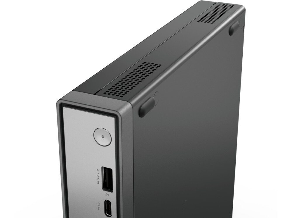 Obraz przedstawia czarną obudowę komputera z widocznymi portami USB i przyciskiem zasilania na przednim panelu. Na górnej powierzchni znajdują się otwory wentylacyjne.
