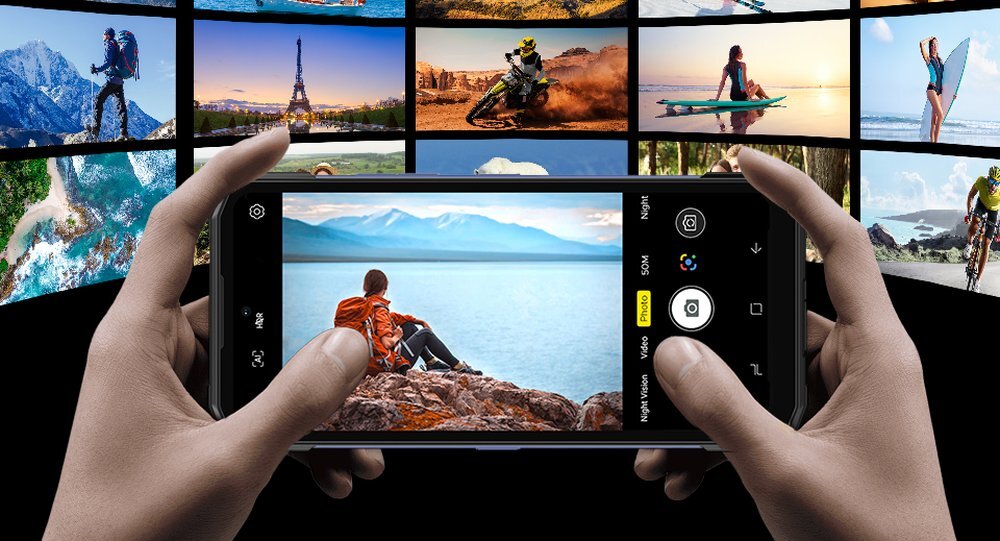 Smartfon DOOGEE Blade 20 w dłoniach ze zdjęciami w tle