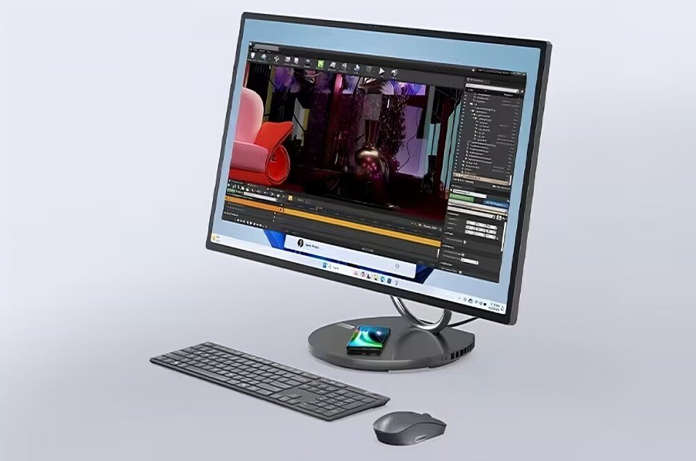 Komputer LENOVO Yoga F0HX0010PB Komputer typu all-in-one z dużym ekranem, klawiaturą i myszą na jasnym tle, na monitorze widoczne jest środowisko graficzne z uruchomionym programem do obróbki wideo, obudowa, wygląd, ładowarka, regulacja nachylenia