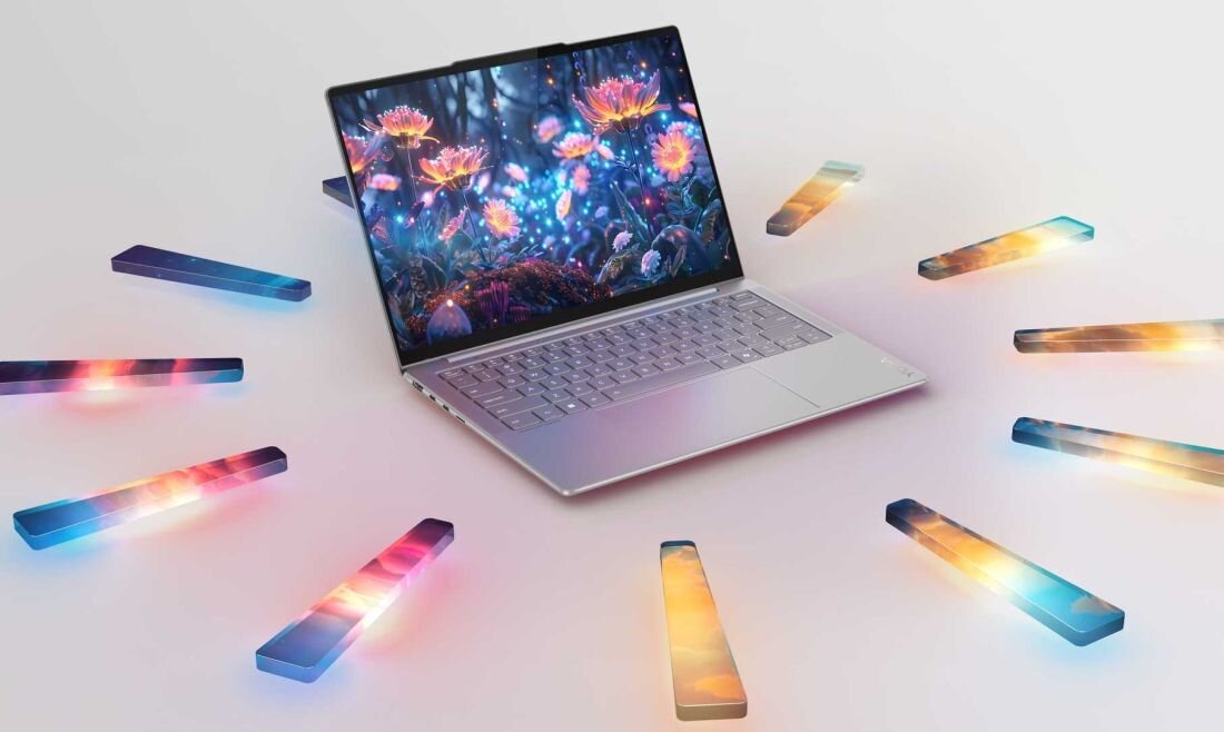 Laptop Lenovo Yoga Slim 7 Aura Edition z ekranem prezentującym kolorowe kwiaty i geometryczne elementy, otoczony kolorowymi pryzmatami świetlnymi na jasnym tle, podkreślający długi czas pracy na baterii. – Bateria do 34 godzin na jednym ładowaniu