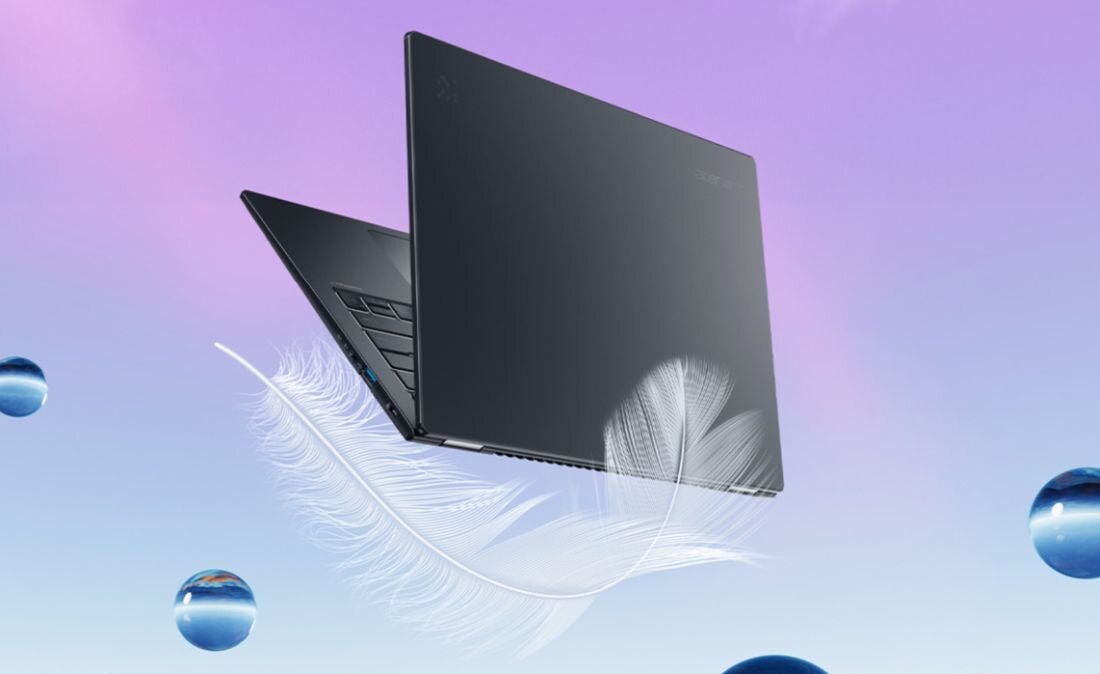 Czarny laptop biznesowy Acer TravelMate w widoku z otwartą klapą z grafiką białych piór i niebieskich różowych szklanych kul unoszących się na pastelowym gradientowym tle fioletowym błękitnym - Lekki sprzęt 