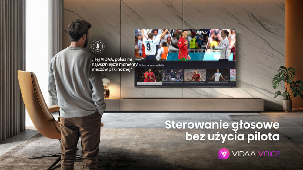 Telewizor HISENSE 55U7Q Pro - Sterowanie głosem bez pilota, Hands-free Voice Control, sterowanie za pomocą głosu, osoba stojąca przed telewizorem zawieszonym na ścianie